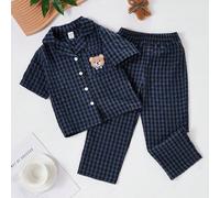 1 Set di pigiami per bambini e ragazzi con colletto a risvolto e maniche corte. Questa biancheria da notte estiva include pantaloni lunghi in un motivo a quadri blu navy e nero decorato con una simpat