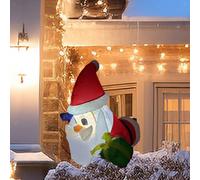 Babbo Natale gonfiabile natalizio che si sporge dalla finestra per il prato