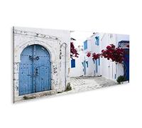 bilderfelix Quadro su tela Porte blu, finestre, muro bianco, edificio Sidi Bou Said, Tunisia - Tela 120x40 cm - Panorama