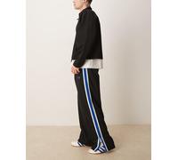 Calvin Klein Jeans - Pantaloni della tuta a righe color nero e blu W34