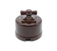 Interruttore di superficie in porcellana marrone, 10 A, 250 V. Ideale per impianti elettrici dal design elegante e resistente.