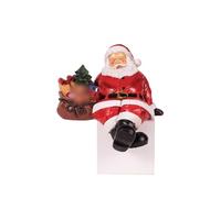 Natale Casa: Statua di Babbo Natale seduto e riposante che tiene una mano. Statuina in resina. Scultura da mensola.