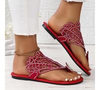 Questo è un paio di ciabatte da donna piatte, con uno stile piuttosto raffinato e lussuoso. Sulla parte superiore delle scarpe ci sono motivi traforati e molti cristalli incastonati. C'è anche una dec