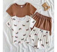 Set estivo per bambini e bambine composto da maglietta a maniche corte con girocollo e pantaloncini, comodo, casual e semplice. La versione bianca latte presenta stampe di simpatici cani cartoni anima