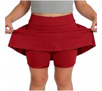 Skort beige da ragazza con sovrapposizione svasata e pantaloncini integrati | Una gonna beige pallido combina una vita liscia, una gonna svasata sovrapposta e pantaloncini aderenti visibili sotto l'orlo