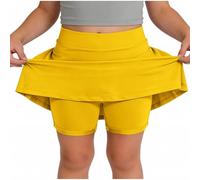 Skort beige da ragazza con sovrapposizione svasata e pantaloncini integrati | Una gonna beige pallido combina una vita liscia, una gonna svasata sovrapposta e pantaloncini aderenti visibili sotto l'orlo