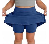 Skort beige da ragazza con sovrapposizione svasata e pantaloncini integrati | Una gonna beige pallido combina una vita liscia, una gonna svasata sovrapposta e pantaloncini aderenti visibili sotto l'orlo