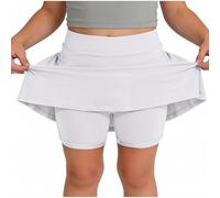 Skort beige da ragazza con sovrapposizione svasata e pantaloncini integrati | Una gonna beige pallido combina una vita liscia, una gonna svasata sovrapposta e pantaloncini aderenti visibili sotto l'orlo