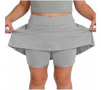 Skort beige da ragazza con sovrapposizione svasata e pantaloncini integrati | Una gonna beige pallido combina una vita liscia, una gonna svasata sovrapposta e pantaloncini aderenti visibili sotto l'orlo
