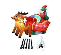 Slitta gonfiabile di Babbo Natale e renne per regalo di Natale sul prato