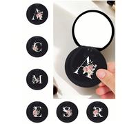 Specchio rotondo nero alla moda con motivo floreale e a lettere - Accessorio da viaggio di design, specchietto mini scorrevole pratico, in materiale plastico, resistente all'usura, leggero e portatile