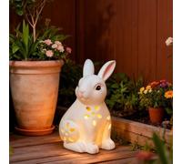 Statua di coniglio pasquale solare bianca design cavo illuminato ornamento coniglio per giardino cortile prato decorazione pastorale festa di primavera all'aperto figura in resina con bagliore