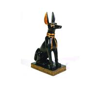 Statuetta raffigurante il dio egizio Anubi in forma di cane seduto, colore: nero e oro.