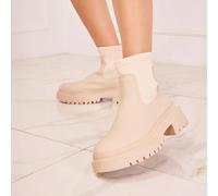 Stivaletti alla caviglia color beige chiaro con suola spessa e tomaia elastica - silhouette pulita e stile audace Cesare imbottigliamenti beige clair se démarquet par leur design monocromo minimalista