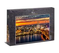 Ulmer Puzzleschmiede - Puzzle "Colonia" - puzzle 1000 pezzi - La città vecchia di Colonia al tramonto con il duomo e il ponte Hohenzollern